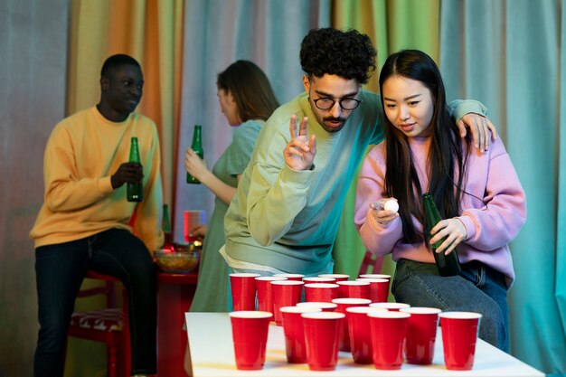 Friends playing beer pong