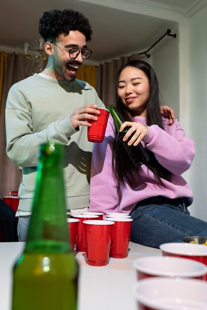 Friends playing beer pong