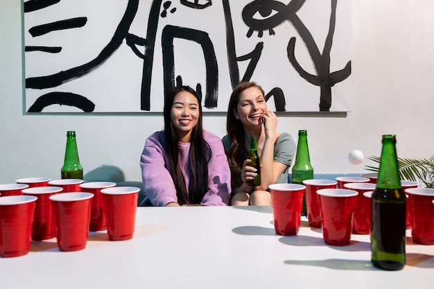 Free photo friends playing beer pong