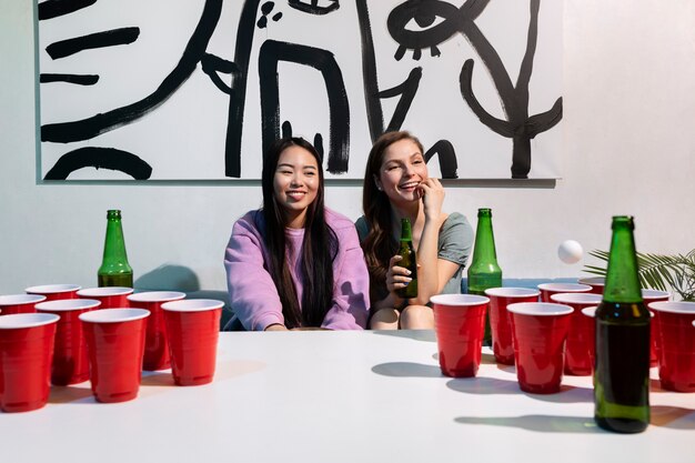 Friends playing beer pong