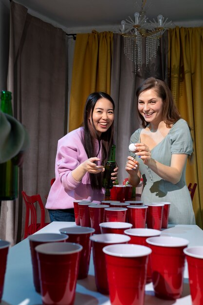 Friends playing beer pong