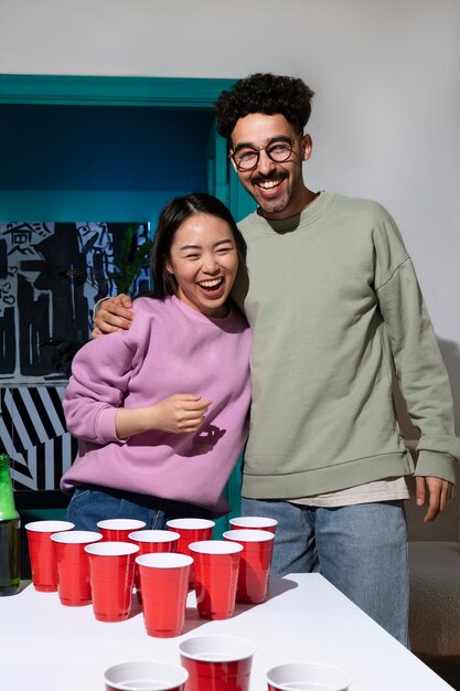 Friends playing beer pong