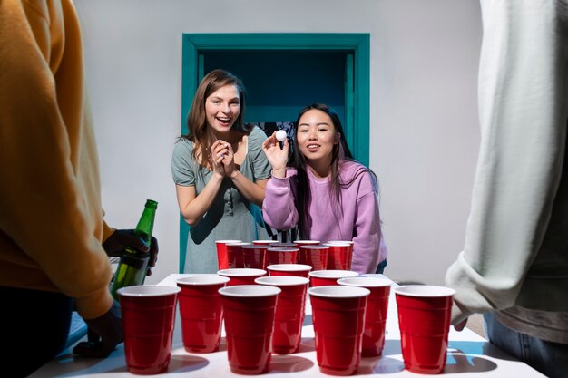 Friends playing beer pong