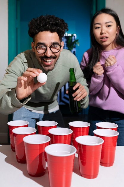 Free photo friends playing beer pong