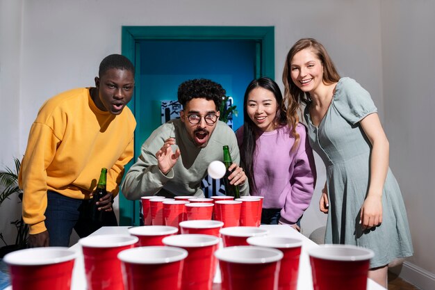 Friends playing beer pong