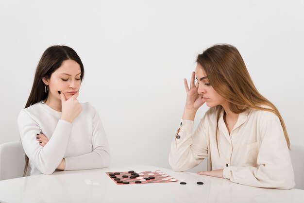 Friends playing checkers at home