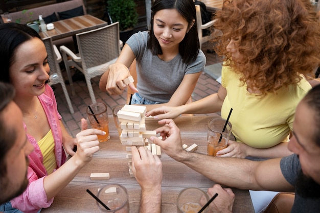 Friends playing game at table close up