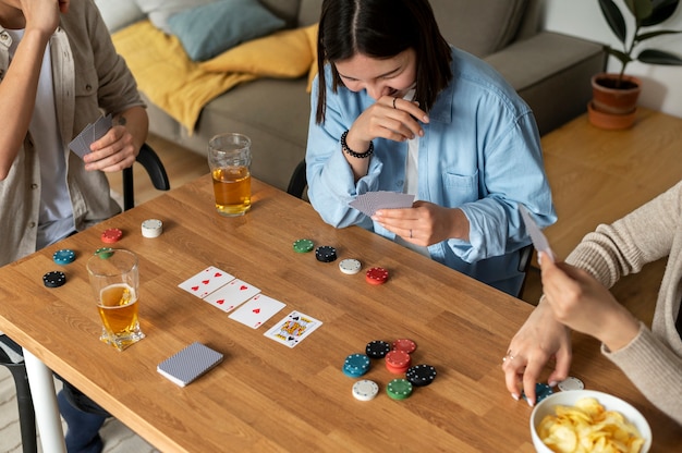 Free photo friends playing poker together