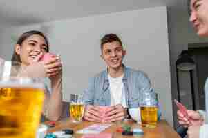 Free photo friends playing poker together