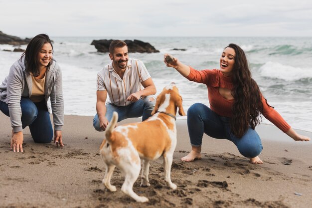 friends playing with dog