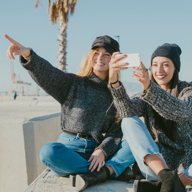 Friends pointing and taking selfie