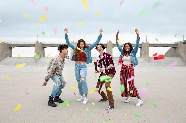 Friends popping confetti while out in the city