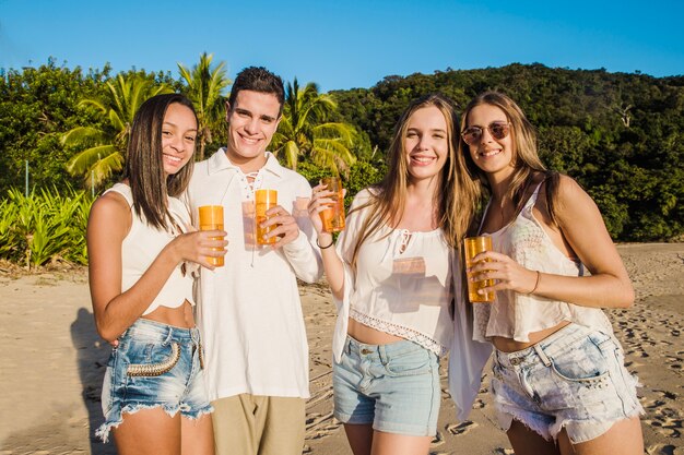 Friends posing at beach party