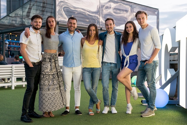 Friends posing at a terrace party