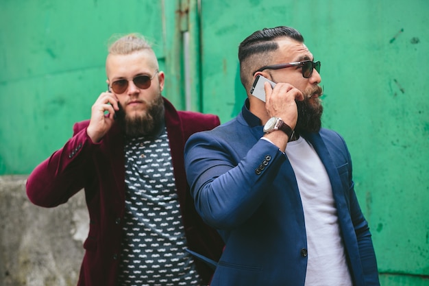 Friends posing while talking on the phone