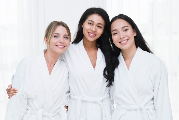 Friends posing with bathrobe in a spa