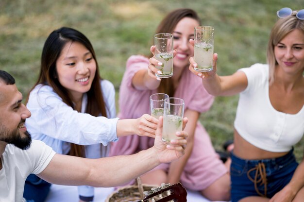 Friends relaxing after pandemic with a glass of lemonade