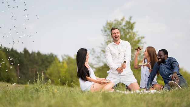 Friends releasing confetti while at a barbecue