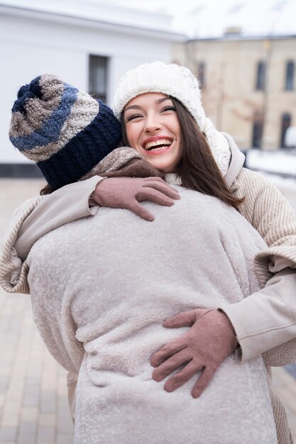 Friends reuniting and hugging after not seeing each other for long time