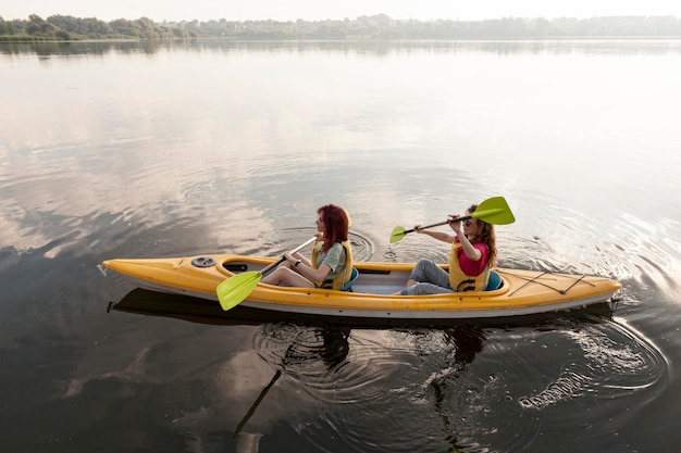 Friends rowing in kayak