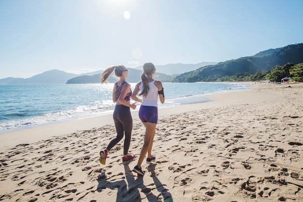 Friends running under the sun