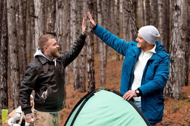 Amici che montano la loro tenda da campeggio invernale