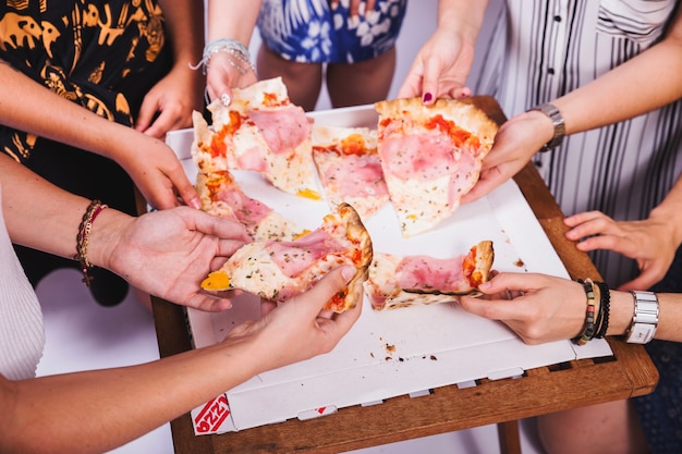 Friends sharing pizza