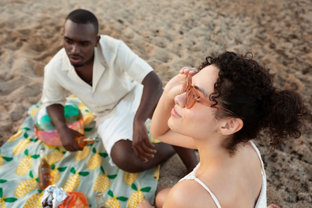 Friends sitting on beach close up