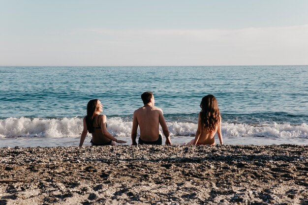 Friends sitting at the beach