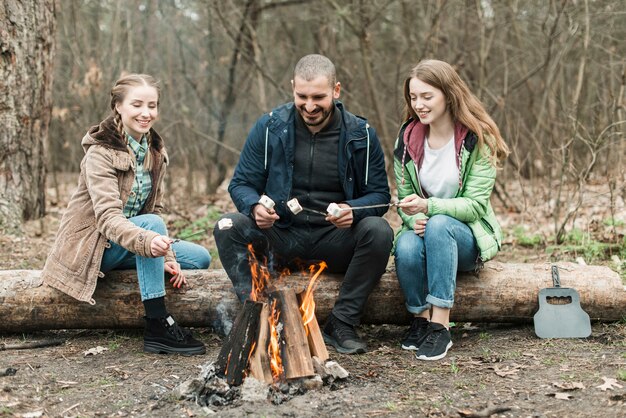 Friends sitting at bonfire