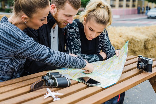 friends sitting and choosing destination