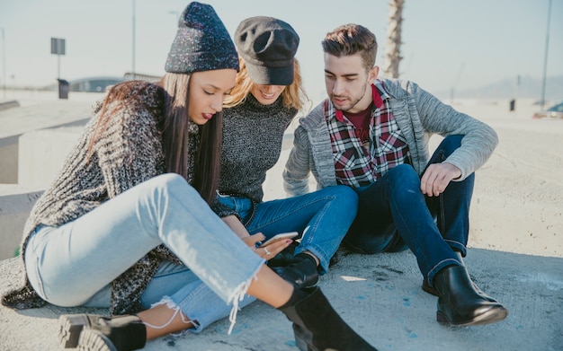 Friends sitting on concrete blocks