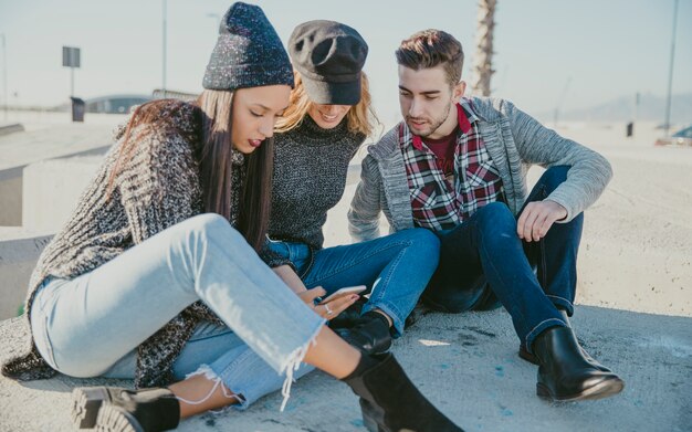 Friends sitting on concrete blocks