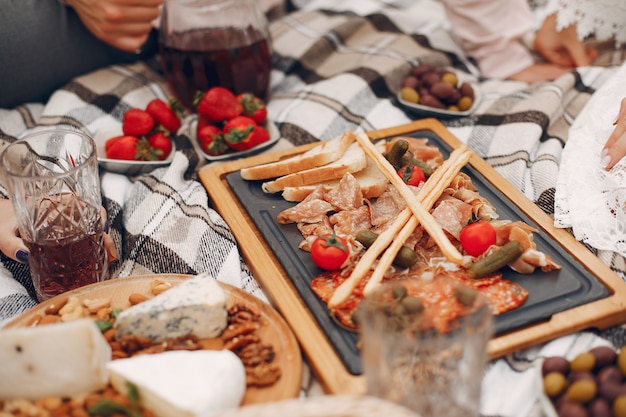 Friends sitting in a garden on a picnic