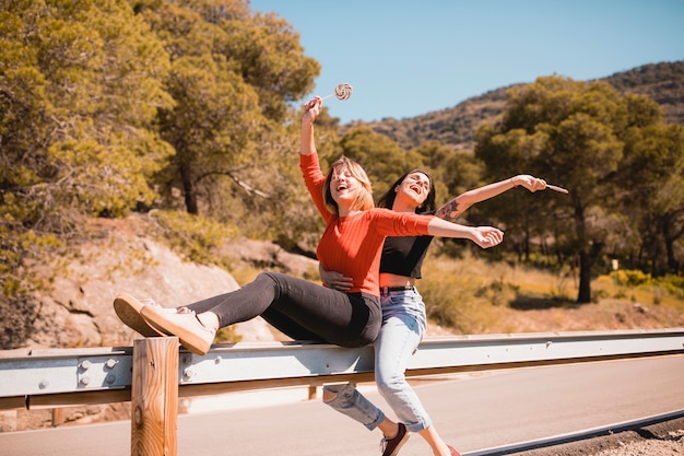 Friends sitting on guard rail