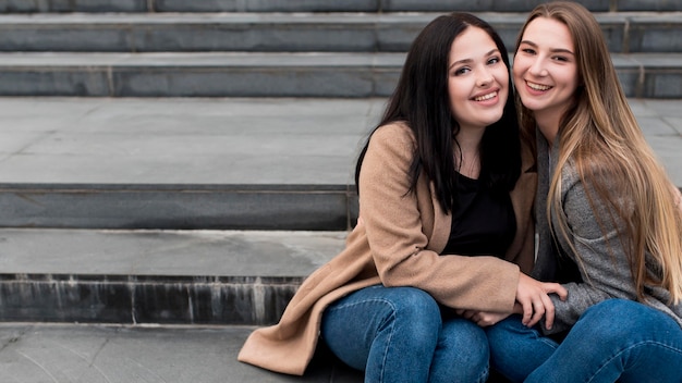 Friends sitting outside on stairs