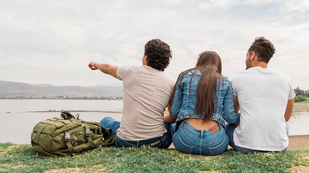 Friends sitting at seaside together