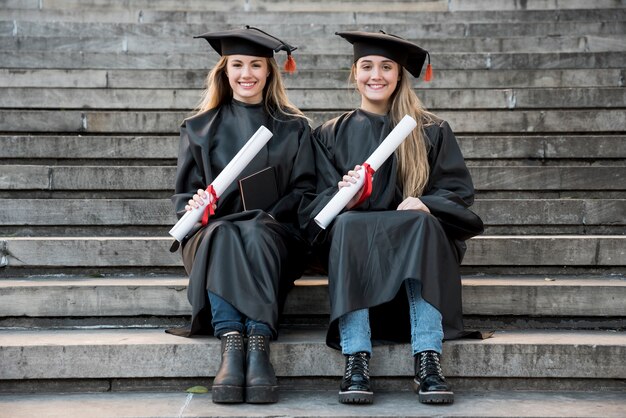 Friends sitting on stairs and looking at the camera