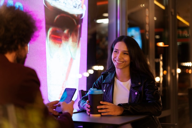 Friends sitting at a table and drinking coffee during a night out