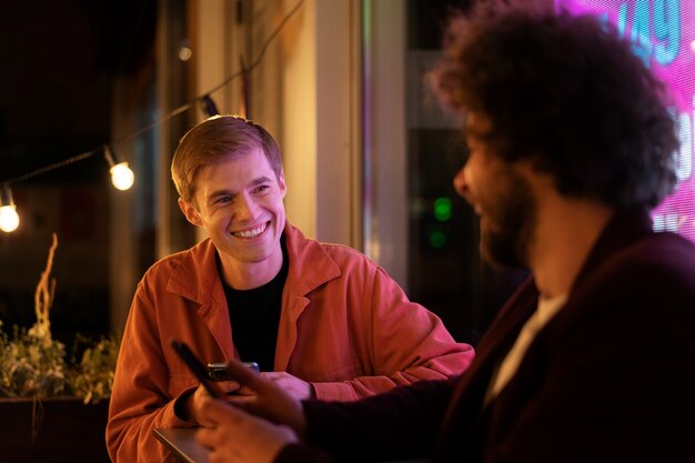 Friends sitting at a table and talking during a night out