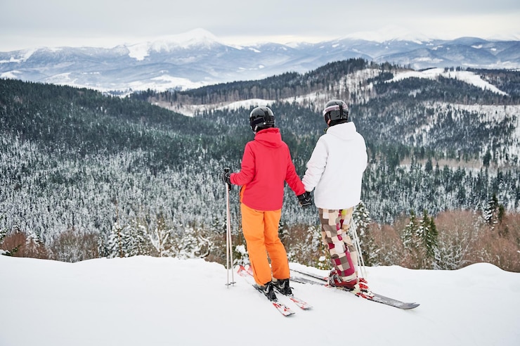 Free Photo friends skiers having fun at ski resort in the mountains in winter skiing and snowboarding
