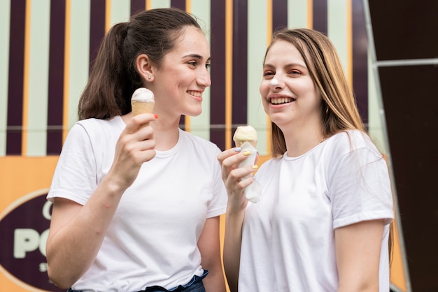 Friends smiling and eating ice cream 