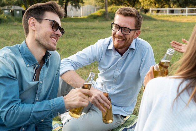 Friends spending time together outdoors and having beer