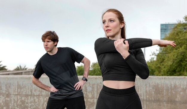 Friends in sportswear exercising outdoors