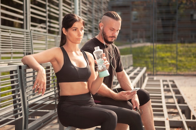 Free photo friends at stadium resting after workout