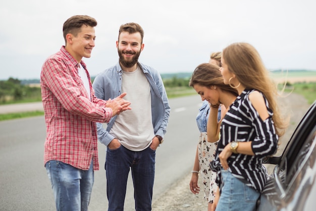 Friends standing on road enjoying together