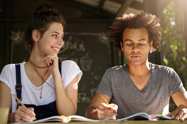 Friends studying together in cafe