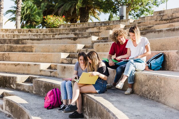 Friends studying together at old stadium 