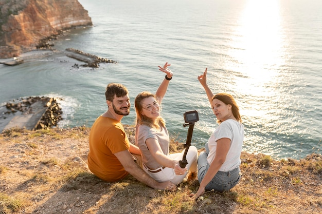 Free photo friends taking a selfie on a coast