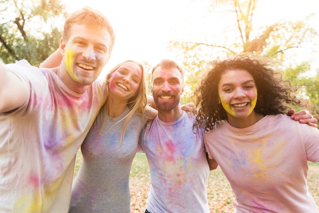 Free photo friends taking a selfie for holi